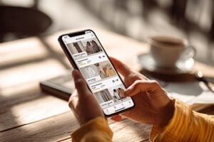 Image of a human hand holding a smartphone