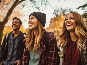 3 colllege aged people — one male and two females — in a park-like setting