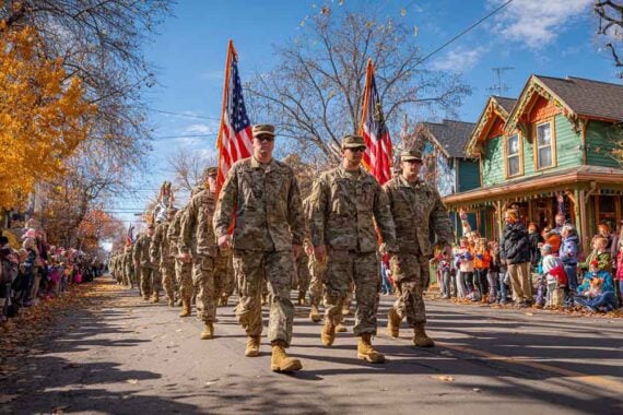 Photo of uniformed military folks marching a parade Photo of uniformed military folks marching a parade