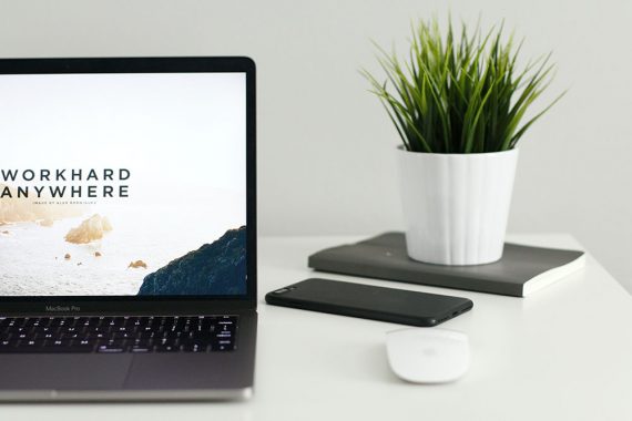 Screenshot of a laptop computer screen with the text "Workhard anywhwere."