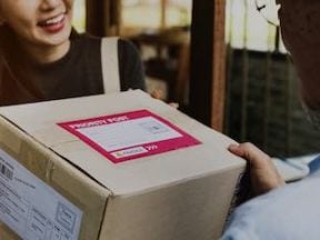 Image of a female receiving a package at her front door