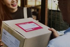 Image of a female receiving a package at her front door