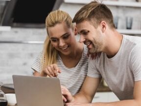 Male and female looking at a laptop computer