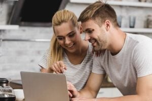 Male and female looking at a laptop computer