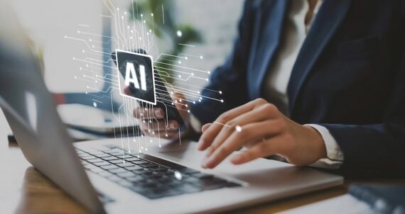 Human hands on a laptop keyboard with "AI" illustration above it Human hands on a laptop keyboard with "AI" illustration above it