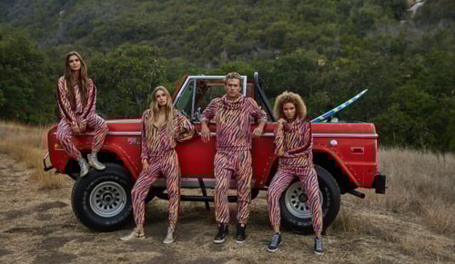 Photo of four teens (or 20s) in front of a vintage Ford Bronco