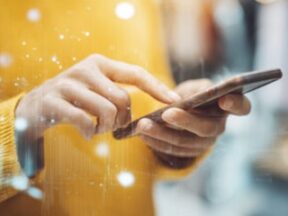 Two human hands holding a smartphone