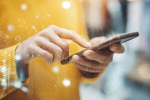 Two human hands holding a smartphone