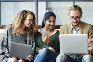 Photos of multi-age consumers on a bench using their devices