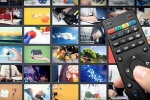 Image of many digital screens and a channel changer