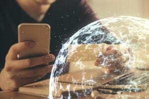 Illustration of a person holding a smartphone next to a globe