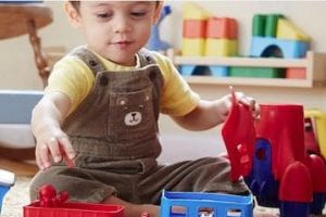 Partial screenshot from Green Toys home page, showing a child playing with toys