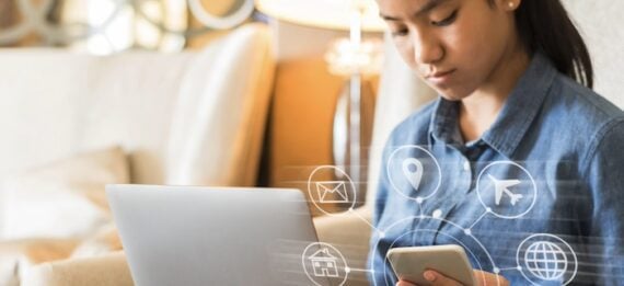 Female looking at a laptop and a smartphone Female looking at a laptop and a smartphone