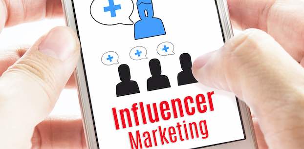 Image of a smartphone with the words "Influencer Marketing" on the screen. Image of a smartphone with the words "Influencer Marketing" on the screen.