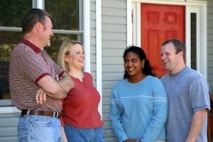 Photo of two couples in front of a local residence