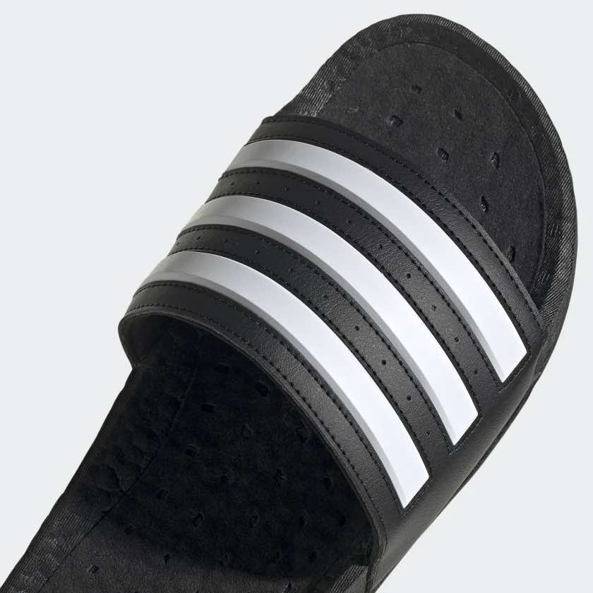 A photo from Adidas.com showing the closeup details of a black sandal A photo from Adidas.com showing the closeup details of a black sandal