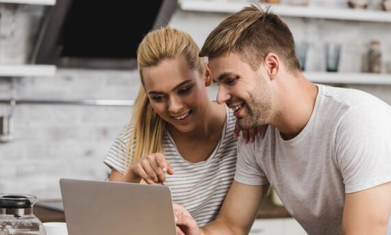 A male and female shopping on a laptop computer A male and female shopping on a laptop computer