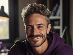 Image from Assureful of a male by a laptop computer