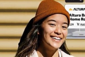 Screenshot from Adobe Commerce of a female holding a computer tablet