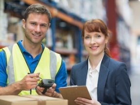 Portrait of manual worker and manager scanning package in the warehouse