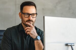 Photo of a male looking at a computer screen