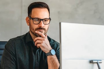 Photo of a male looking at a computer screen