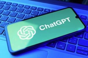 ChatGPT logo on a smartphone screen, which is on a keyboard