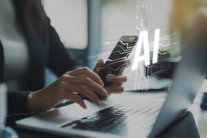 Photo of human hands on a keyboard with the letters "AI" overlaid