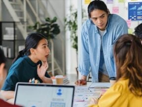 Digital marketers in a meeting around a table