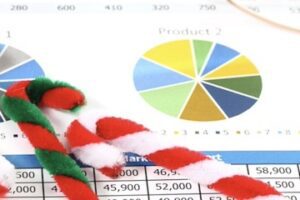 Illustration of bar graphs with Christmas items on top