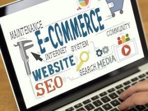 Photo of a laptop screen with ecommerce text and symbols on it