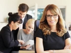 Photo of a female with staff in a business setting