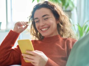 Image from ESW of a female looking at a smartphone