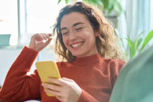 Image from ESW of a female looking at a smartphone