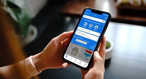 Photo of human hands holding a smartphone with the Walmart app Photo of human hands holding a smartphone with the Walmart app